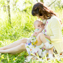 Mother breastfeeding baby outside