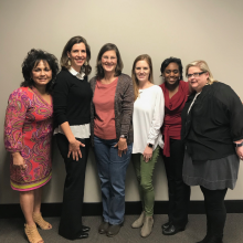 Six women standing side by side