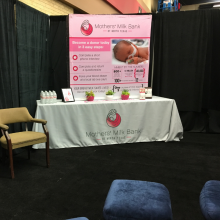 Room with changing tables, glider rockers, and milk bank informational materials