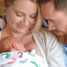 Mother and father holding newborn baby