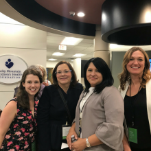 Four women standing in lobby of office