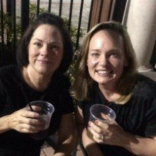 Two women sitting on a patio