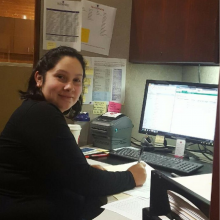 Woman sitting at her office desk in front of computer