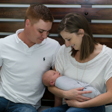 Mother and father holding newborn son