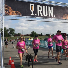 5 people and 1 dog crossing a race finish line