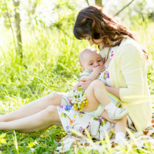 Mother breastfeeding baby outside