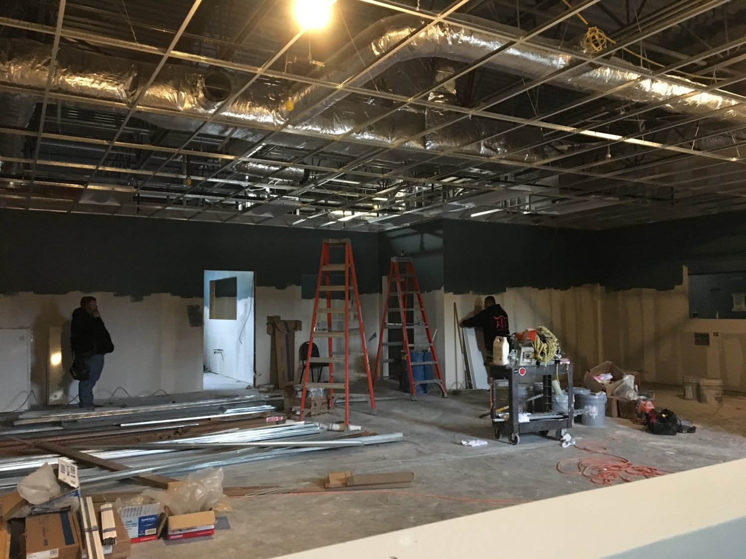 Two men working in indoor construction site