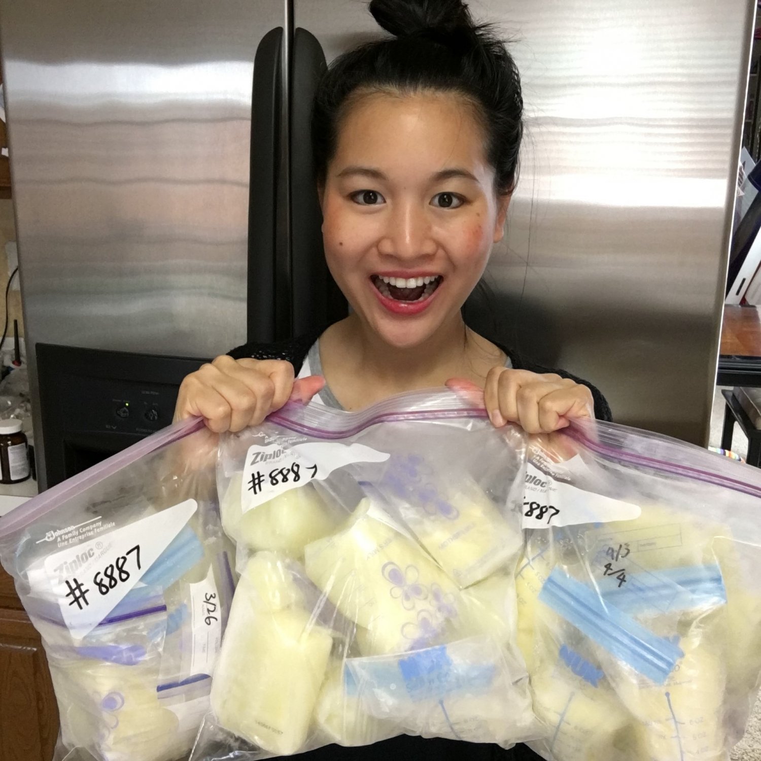 Mother holding bags of her frozen breastmilk