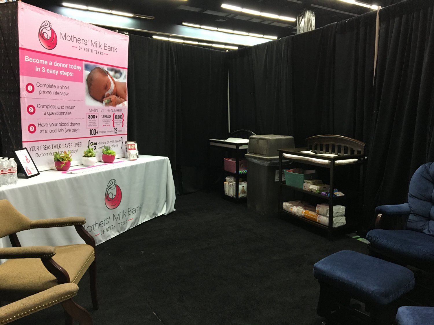 Room with changing tables, glider rockers, and milk bank informational materials