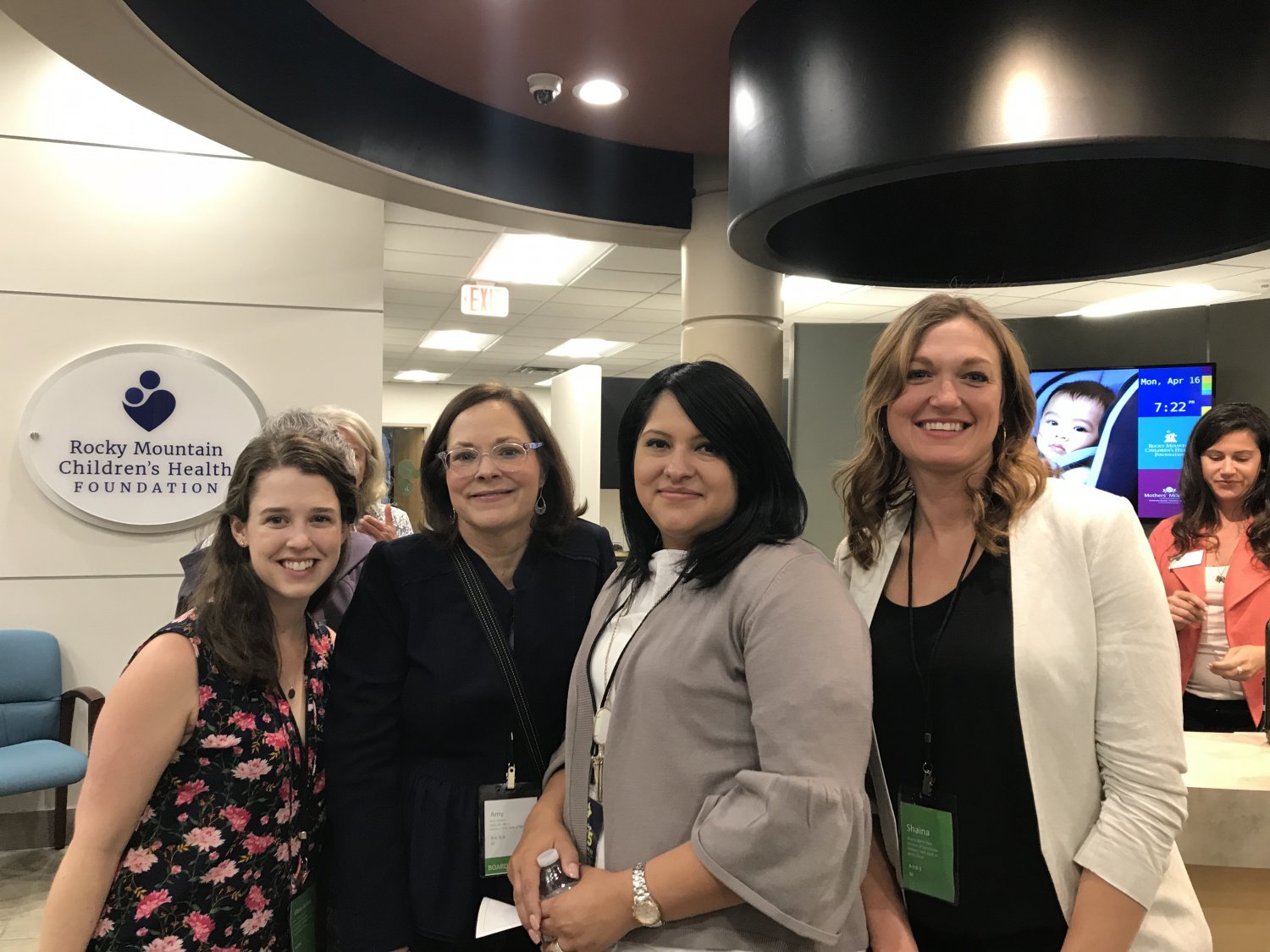 Four women standing in lobby of office