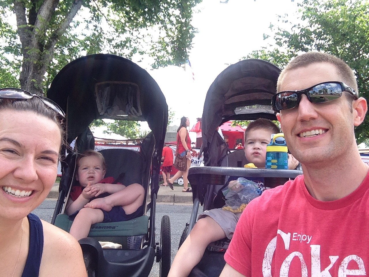 Mother and father with two children, each in a stroller