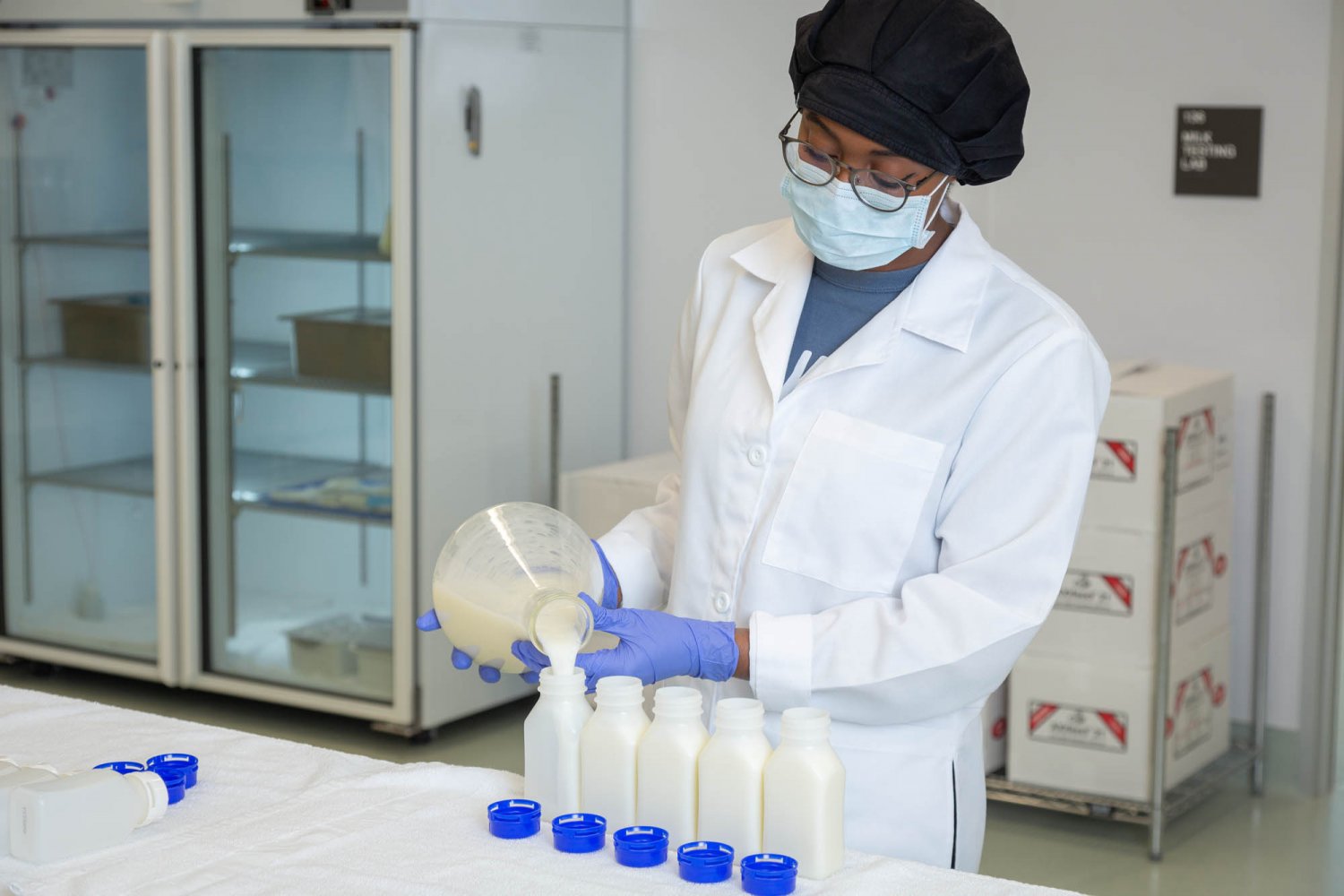 Woman pouring breastmilk from a flask to a bottle