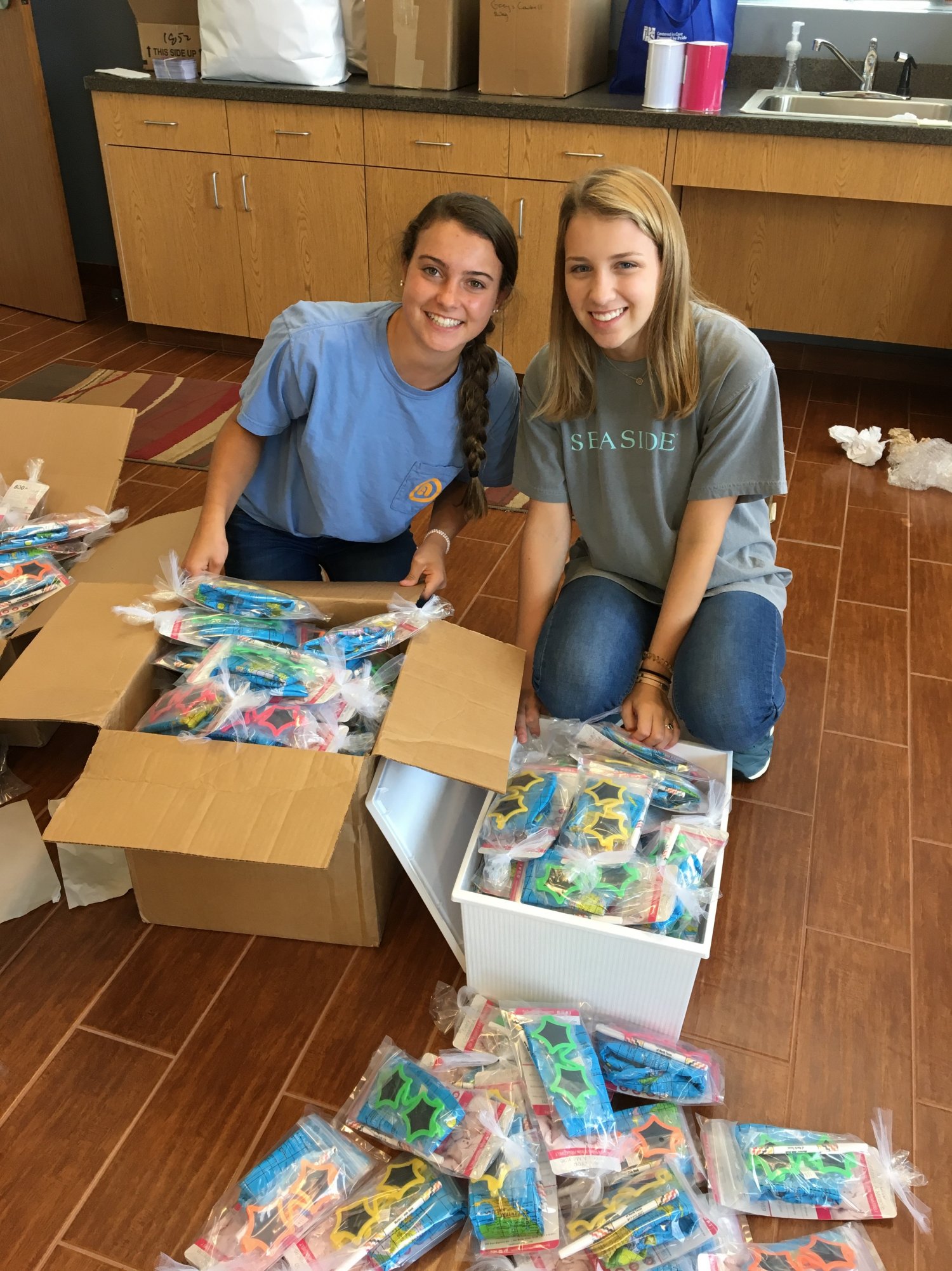 Two teenage girls assembling packets