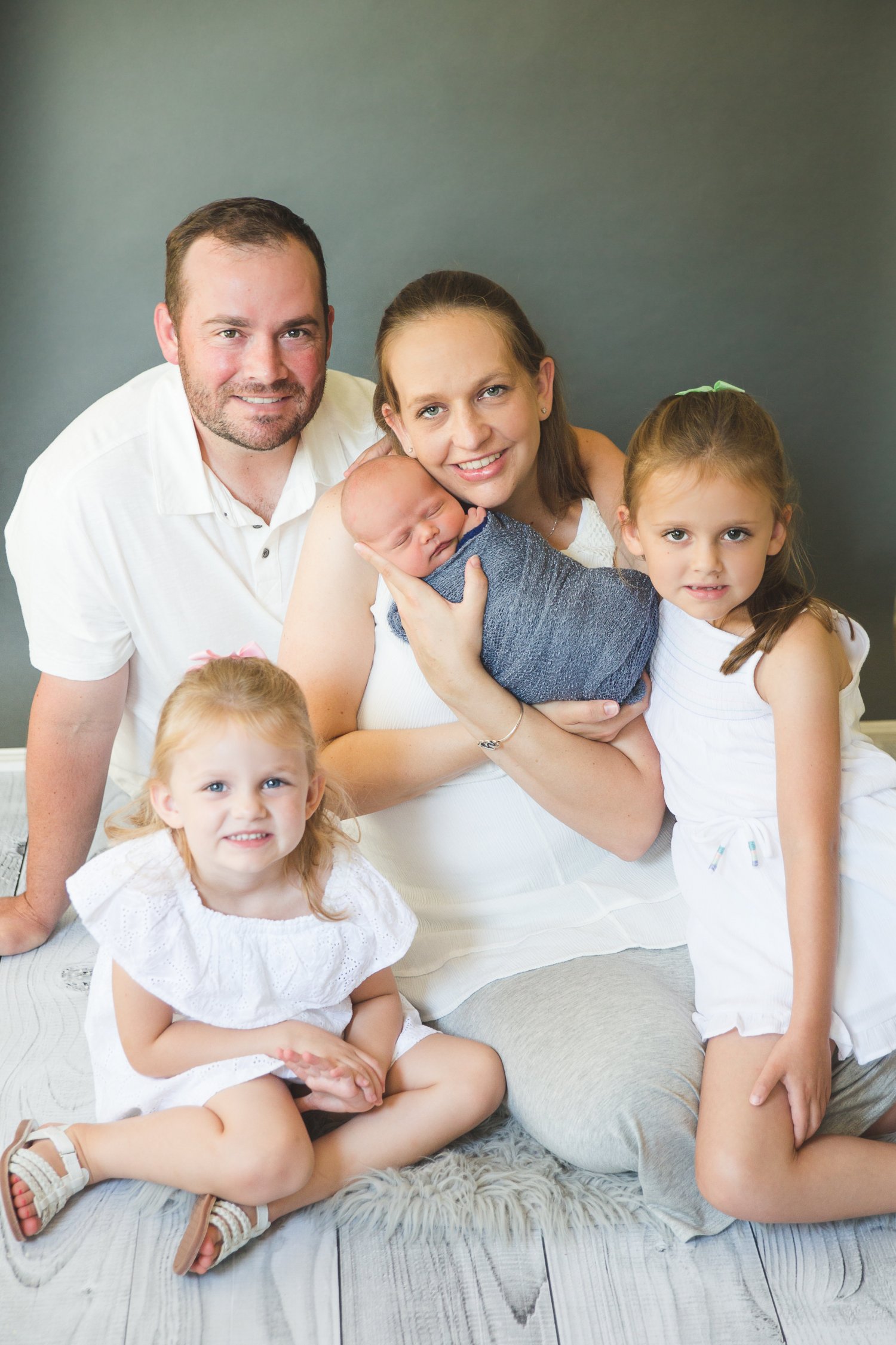 Mother, father, two young daughters, and infant son