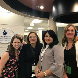 Four women standing in lobby of office