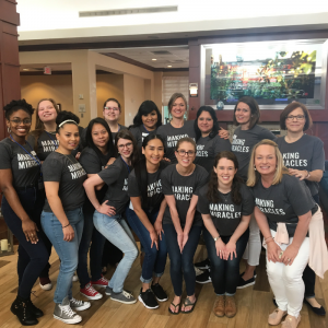 Fifteen women in matching shirts